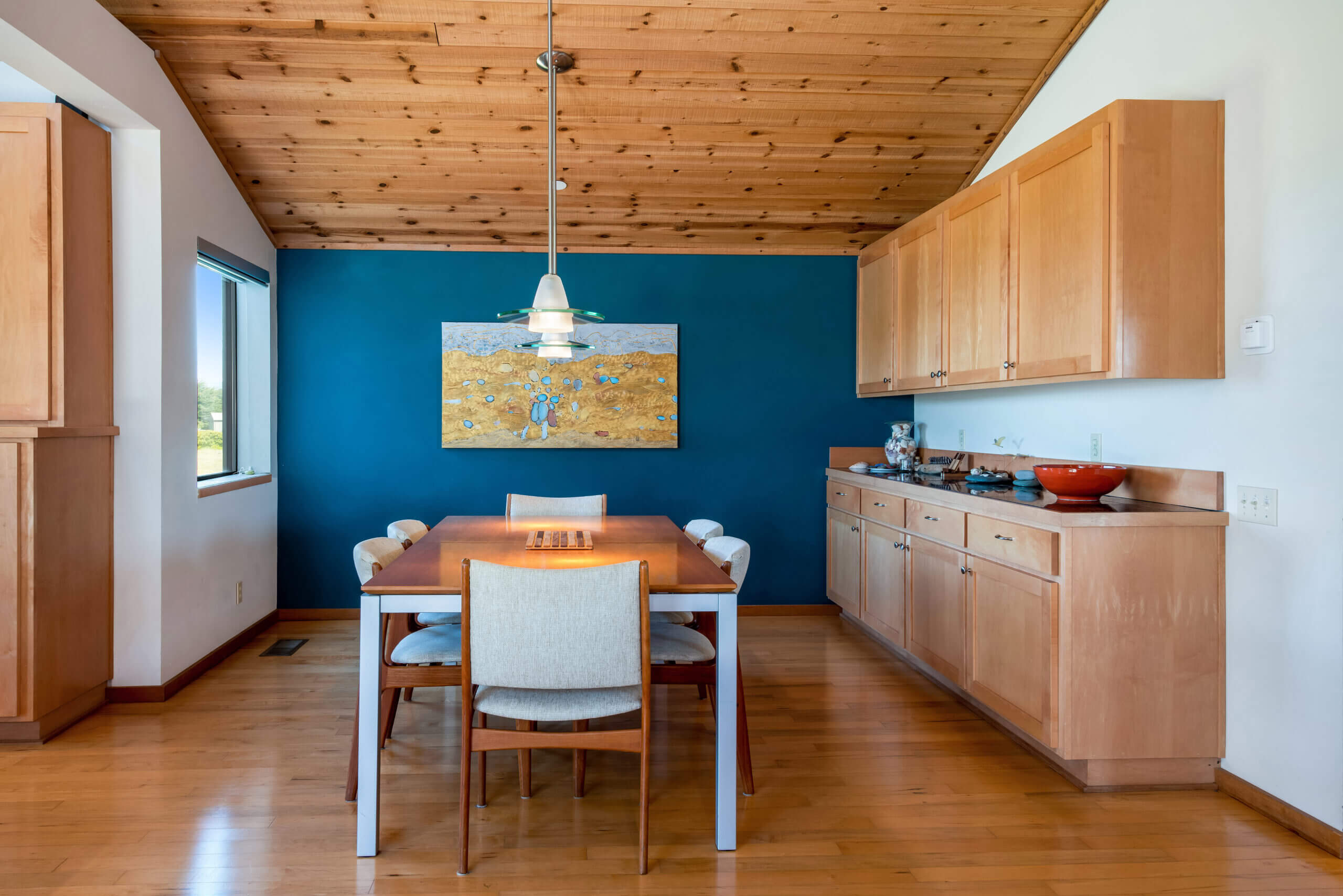 Bella Luna dining table, blue wall and wood ceiling