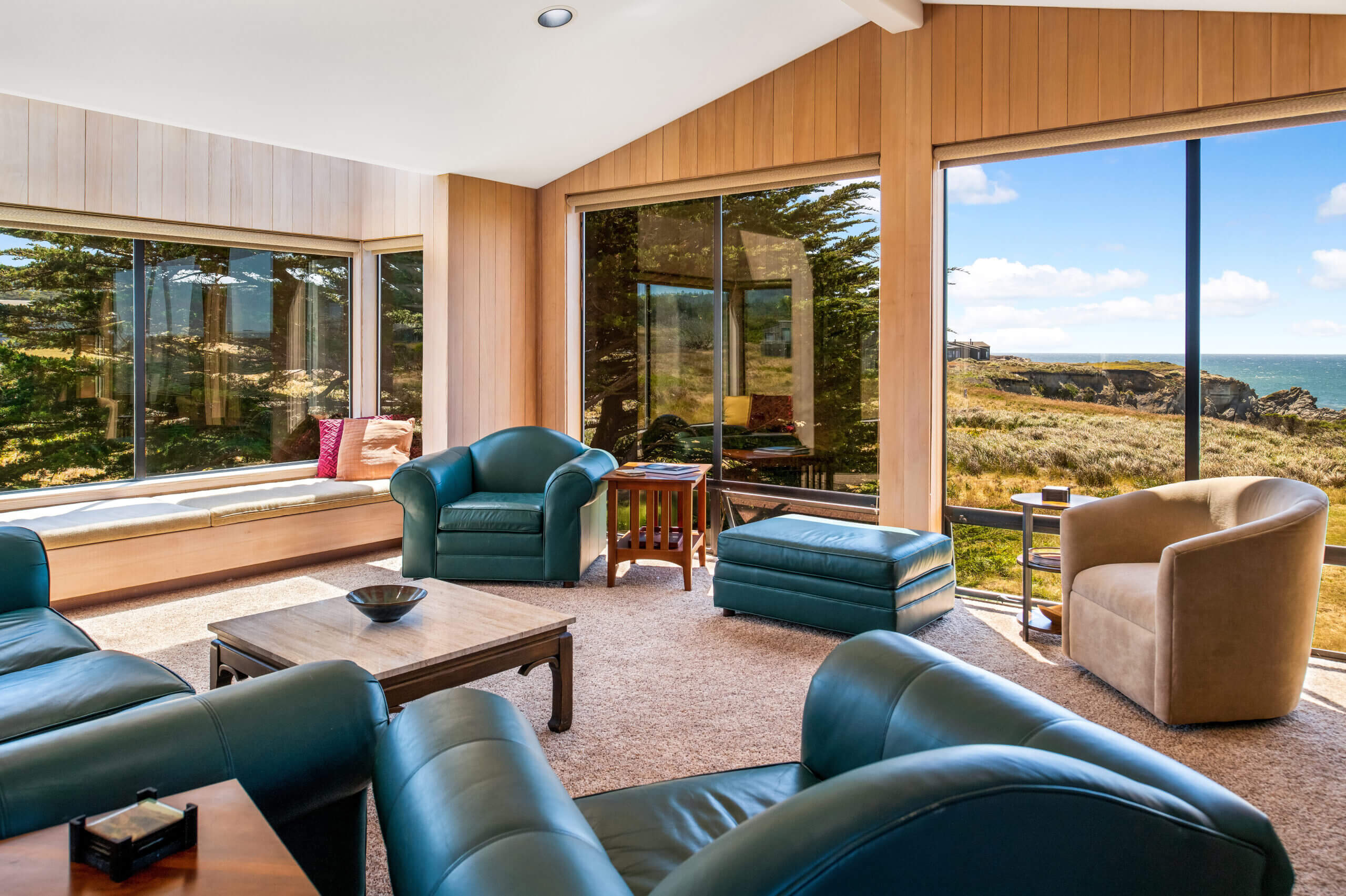 Piper's Dream living room, large windows with view of meadow & ocean
