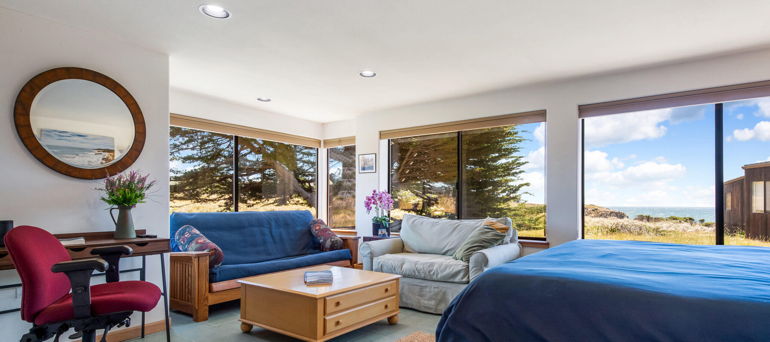 Piper's Dream master bedroom, sitting space, desk, large windows of ocean meadow