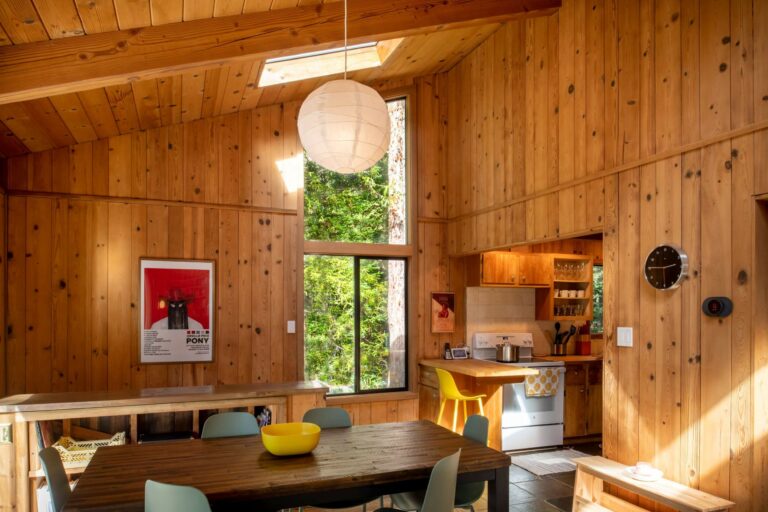 Sea Pony - bright wood paneled dining room with view to kitchen