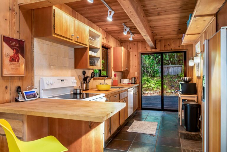 Sea Pony - bright wood paneled kitchen with glass doors to outside