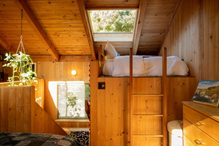Paradiso - wooden ladder to loft bed, skylight and bright wood paneled walls